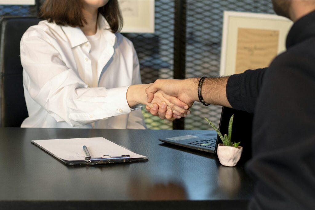 Business handshake over signed documents
